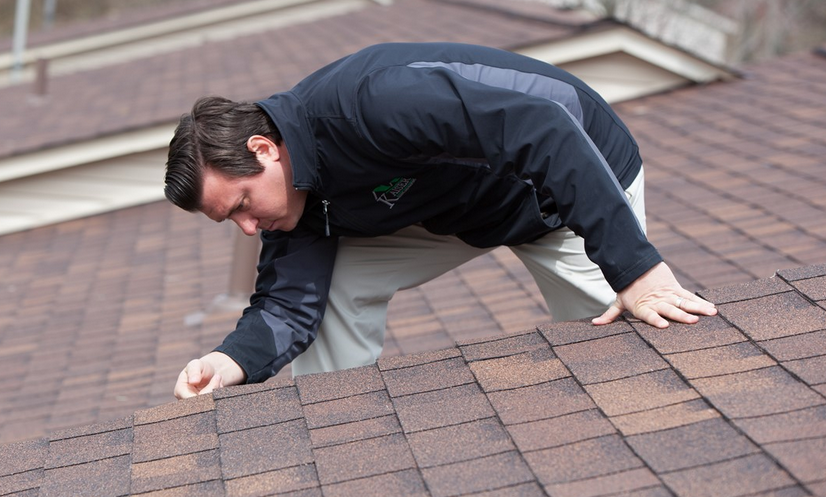 Inspector looking at a residential roof